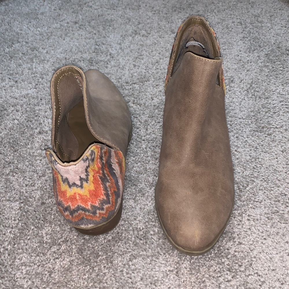 Tan booties with yellow/orange/grey detail on the heel